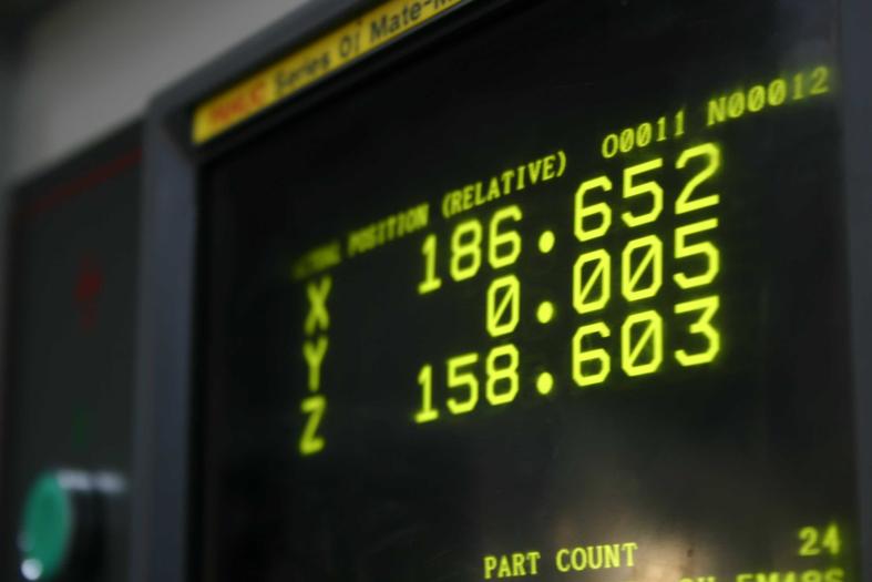 CNC machine display, showing precise XYZ coordinates during operation
