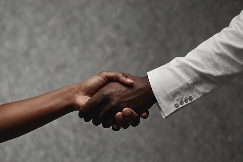 Two people shaking hands as a symbol of partnership