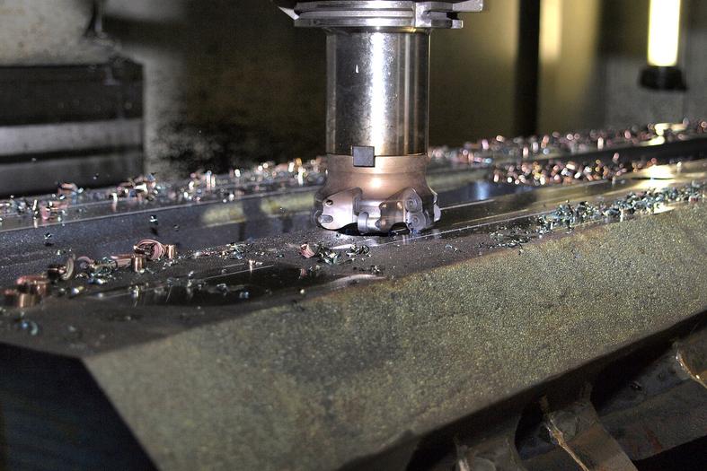 CNC milling machine cutting a metal piece, precision machining in action