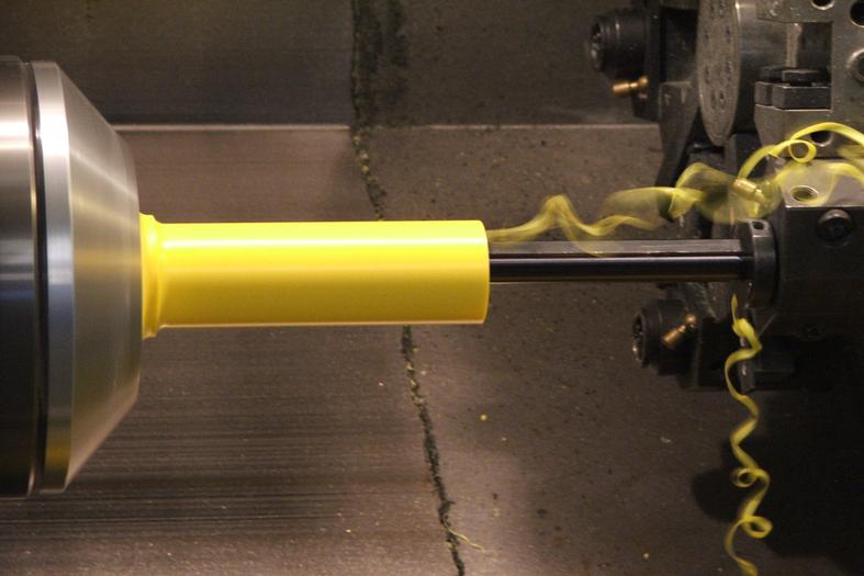 CNC lathe machining plastic material, producing precision parts with clean cuts