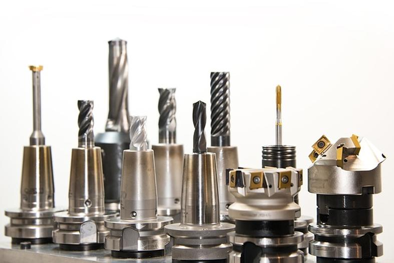Assorted CNC machining tools, including end mills, thread taps, and face mills