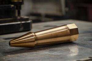 Custom machined brass component, featuring precise edges and polished finish