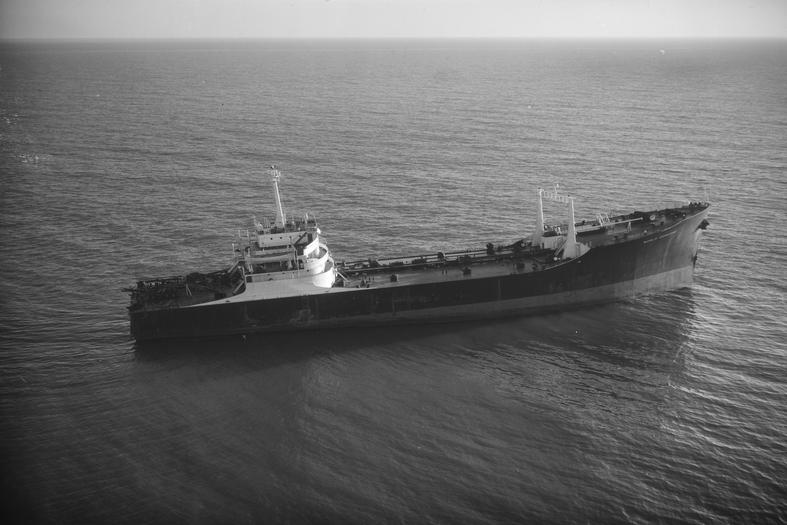 Large cargo ship floating on calm ocean waters
